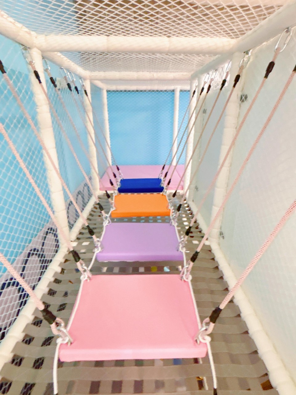 Soft rope bridge with colorful stepping seats